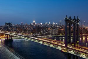 Scenic nighttime view of Manhattan Bridge from New York’s Pier 36 waterfront.