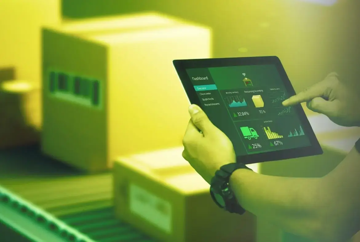 An inventory planner uses OneTruth to analyze data on a tablet in a warehouse. 