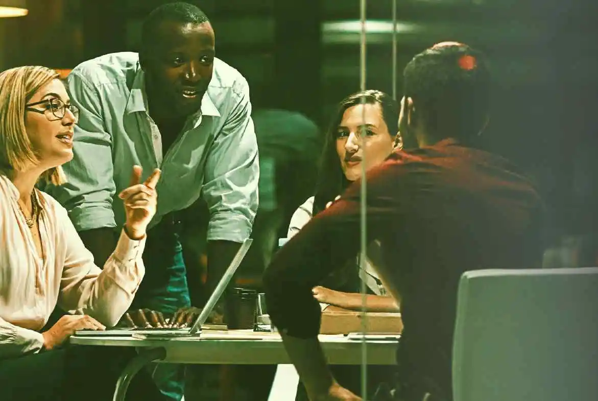 A group of inventory planners gather in a conference room.